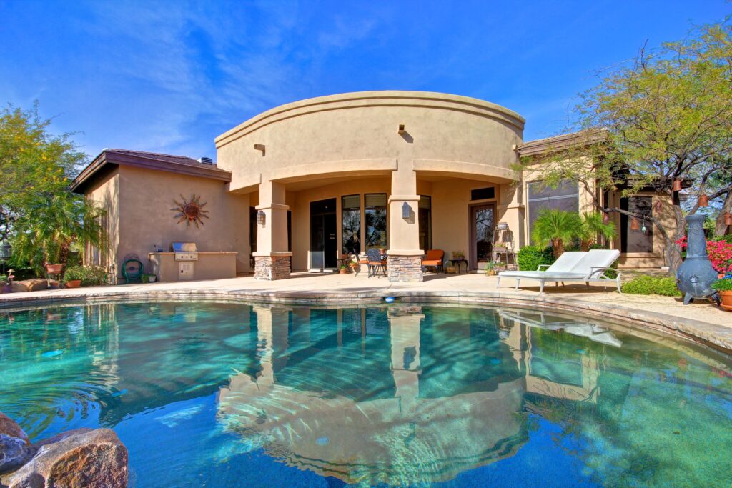 Backyard with covered patio and heated pool and spa