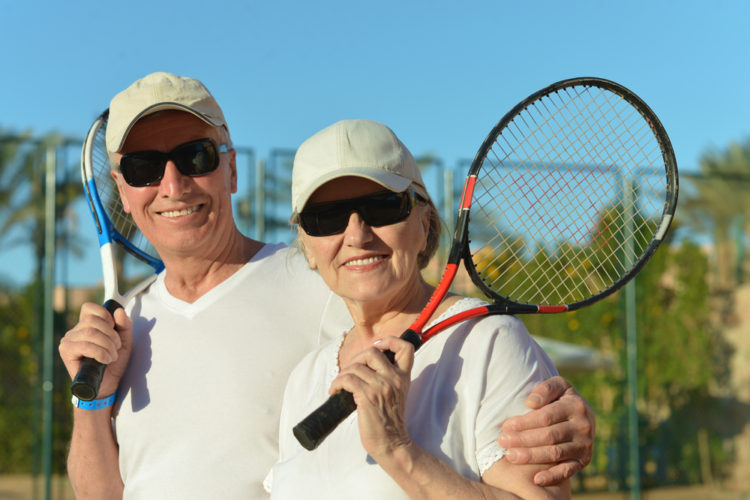 Increasing retirement population in Arizona, seniors playing tennis in an active adult community