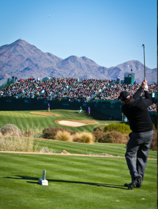 Pro golfer teeing off at the Waste Management Phoenix Open